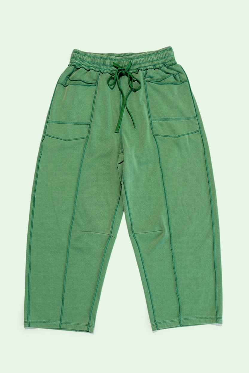 Green pants with drawstring waist on a light green background