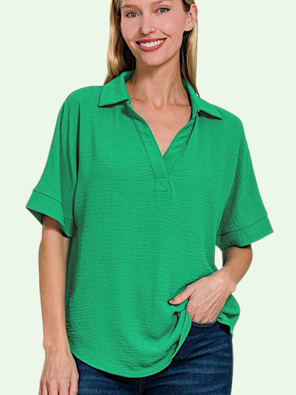 Woman wearing a green v-neck shirt on a light green background