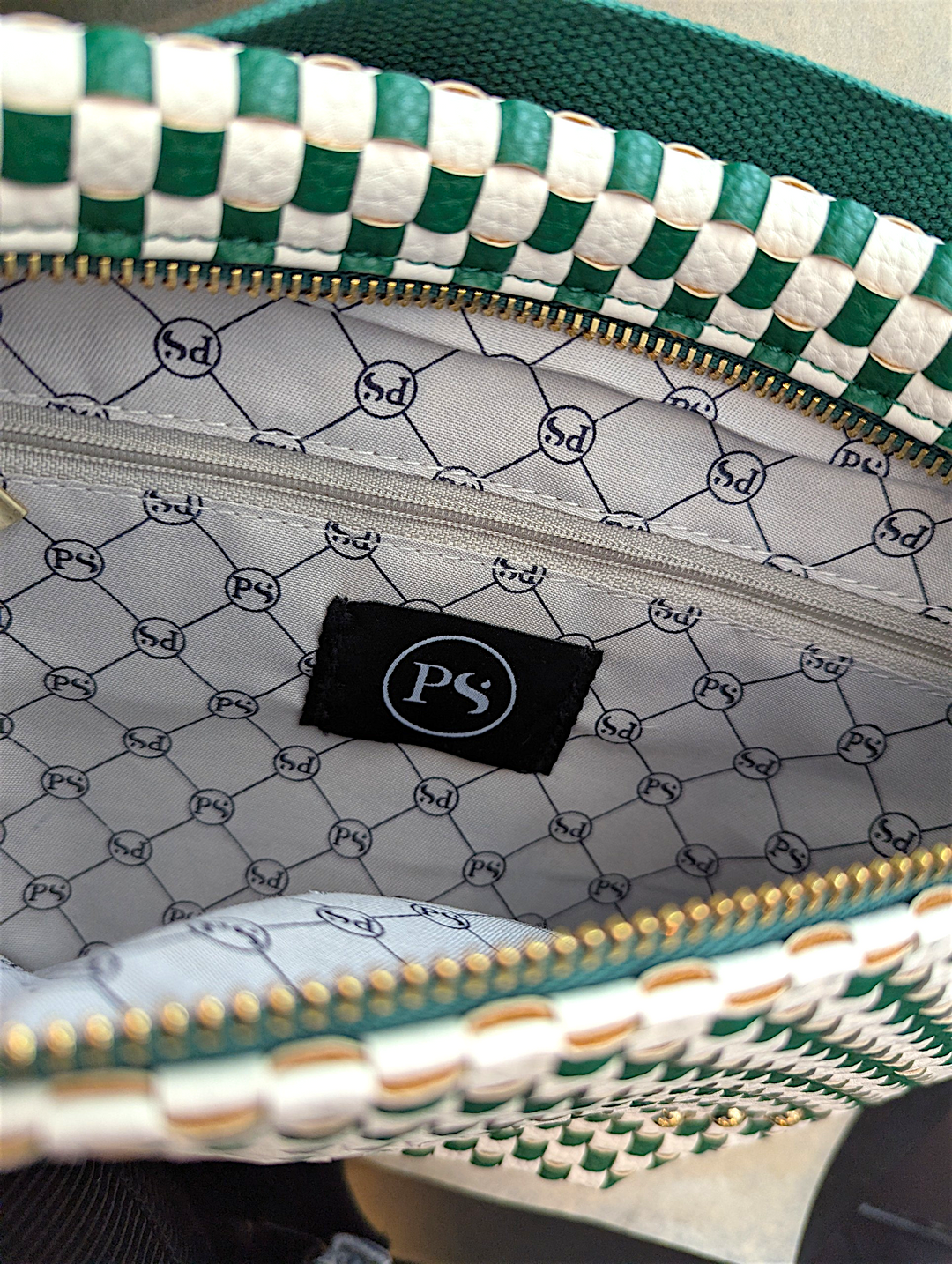 Close-up of the inside of the westlyn green and white checkered bag with a patterned interior and visible brand logo.