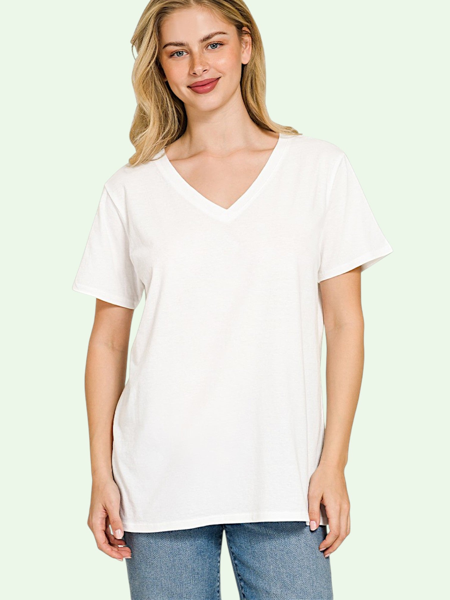 Woman wearing a white t-shirt against a light green background
