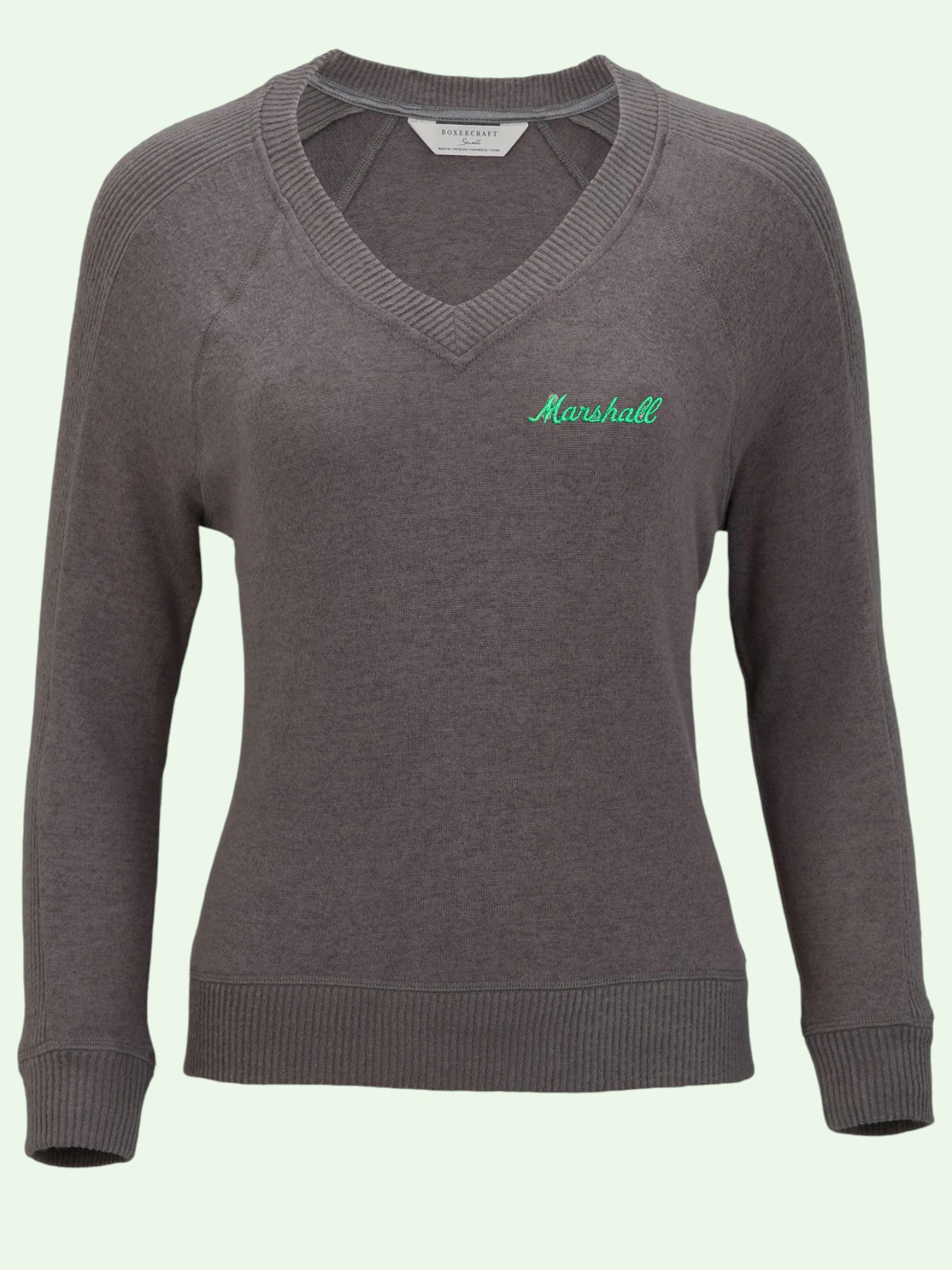 Gray sweater with 'Marshall' logo on a light green background