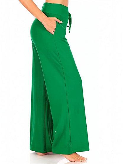 Green wide-leg pants worn by a person on a green background