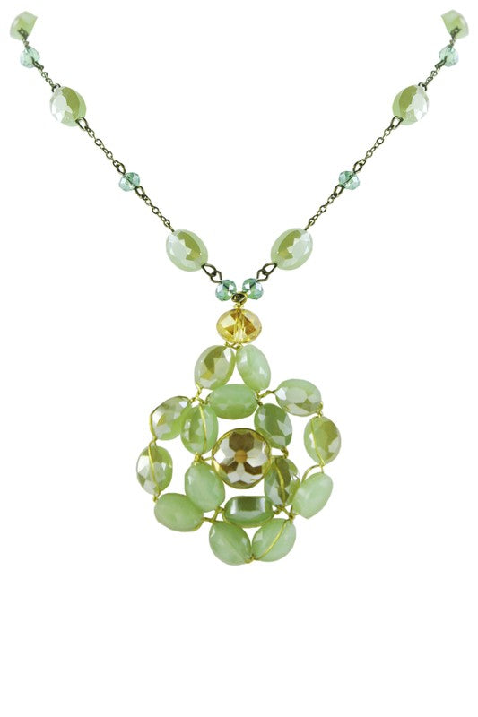 A necklace with a green crystal flower pendant and a gold-colored clasp, on a white background.