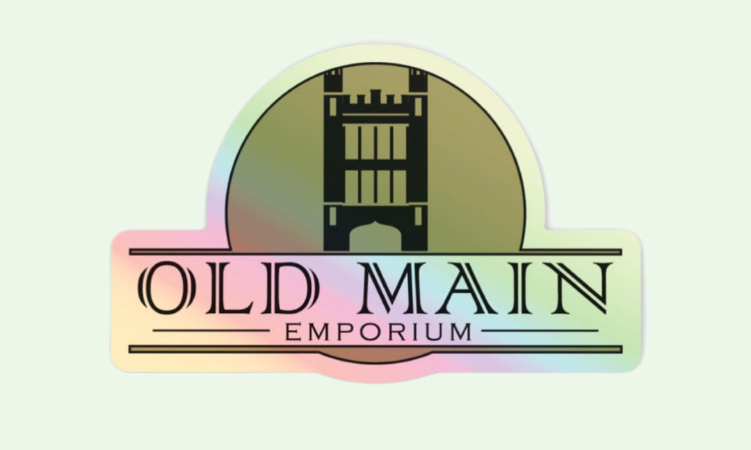 a holographic sticker of the Old Main Emporium logo