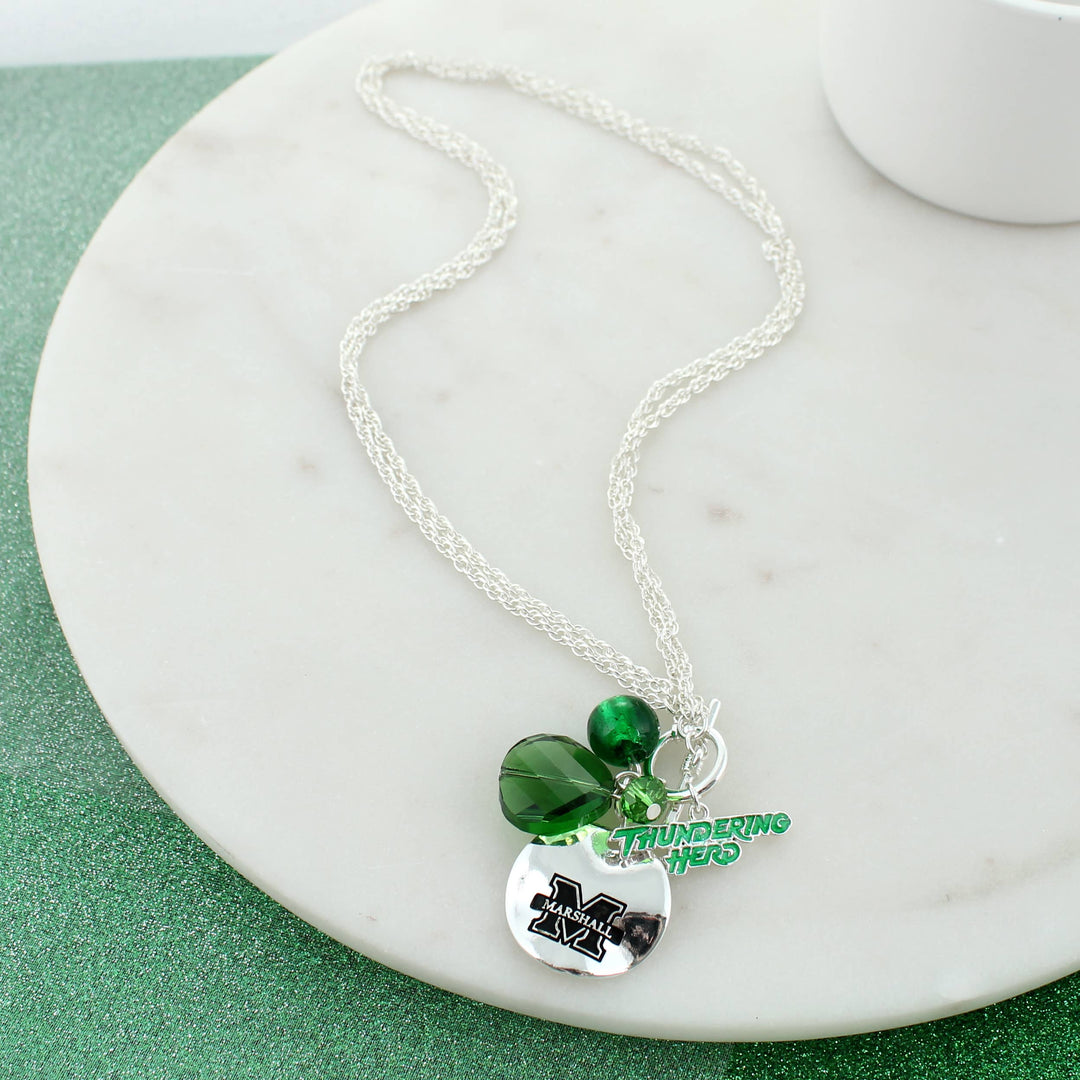 Marshall Necklace with green bead charms, Thundering Herd Charm and Silver disc charm with Marshall M logo laying on white surface